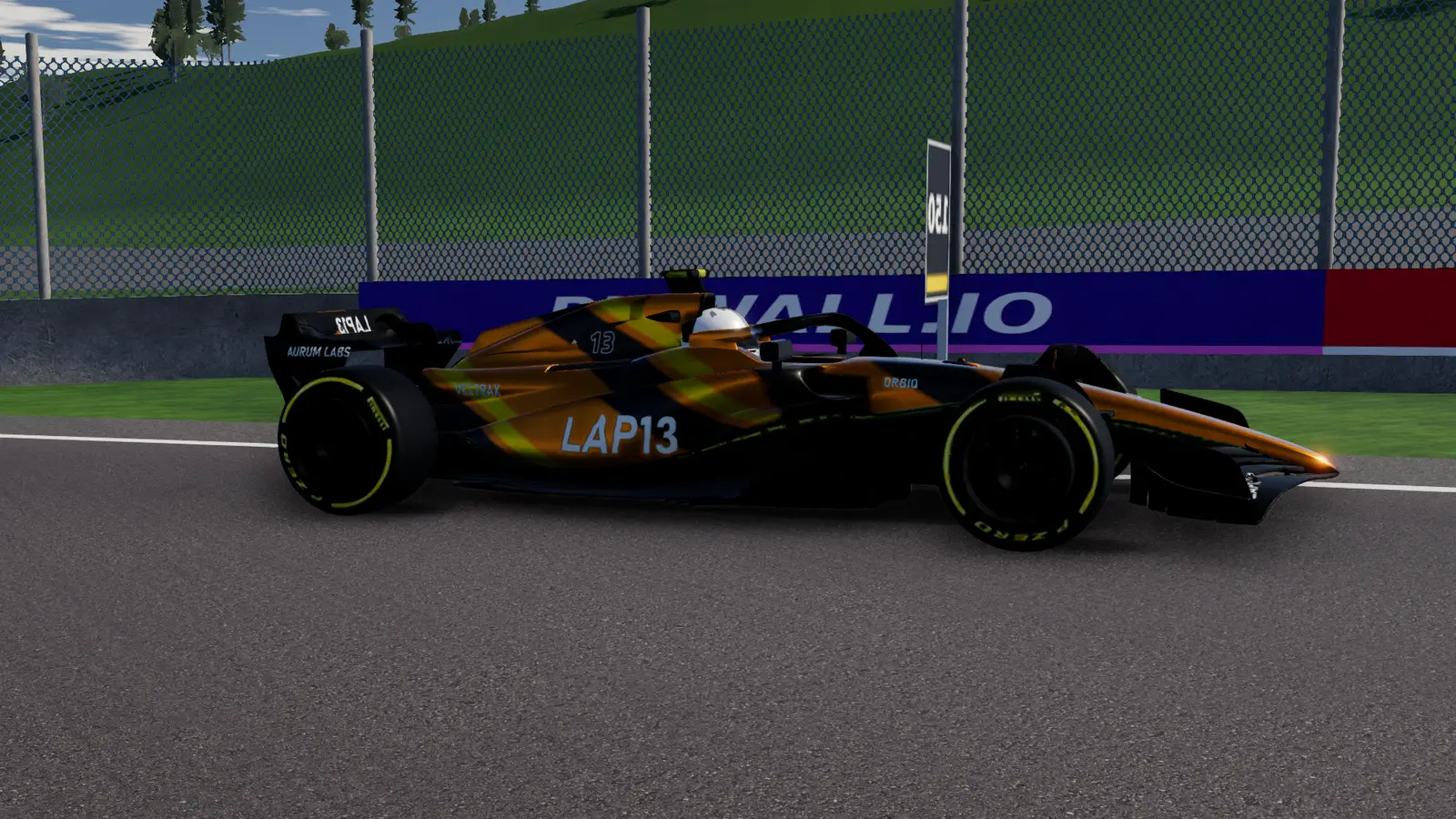 The LAP13 car side on in black and gold, the Ardennes hillside behind